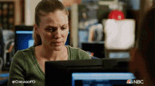 a woman is sitting in front of a computer screen with the hashtag #chicagopd