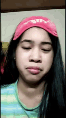 a woman wearing a pink headband that says ' ain ' on it
