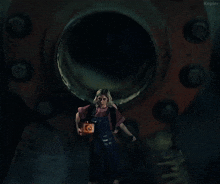 a woman standing in front of a pipe with the words let 's fucking go written below her