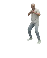 a man in a grey shirt and jeans is dancing