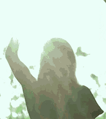 a woman is standing in front of a window with the sun shining through the window