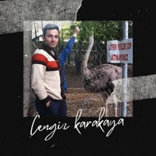 a man is standing next to a ostrich in a cage .