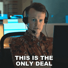 a man wearing headphones is sitting in front of a computer and says this is the only deal