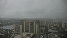 an aerial view of a city on a cloudy day with a hotel in the foreground