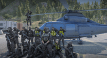 a group of police officers are posing for a photo in front of a helicopter