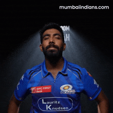 a man in a blue shirt that says mumbai indians on it