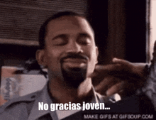 a man with a beard says no gracias joven on a gif