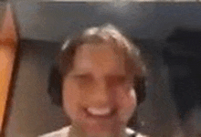 a close up of a person wearing headphones smiling .