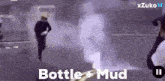 a bottle of mud is being sprayed on a person 's head .