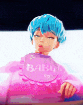 a girl with blue hair is wearing a pink baby bib