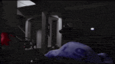 a person is laying on a bed in a dark room with a purple blanket .