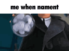 a man in a suit and tie is holding a bubble with the words me when nament on it .