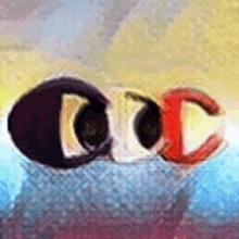 a close up of a pair of earrings with the letters cc on them .