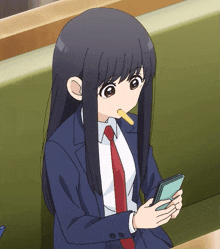 a girl with long black hair is sitting on a bench eating a candy bar and looking at her phone