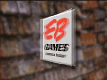 a sign that says eb games on it in front of a wall of books