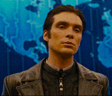 a man with a zipper around his neck stands in front of a blue background