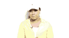 a woman wearing a white hat and a neon yellow jacket is making a face .
