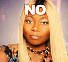 a woman with blonde hair has the word no on her face