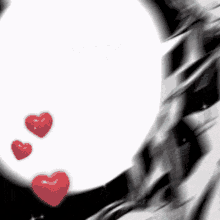 three red hearts are flying in front of a white circle