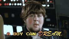 a man with a beard says " a boy can dream " on a screen