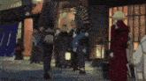 a group of people standing outside a building with a sign that says ' a ' on it