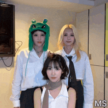 three women are posing for a picture and the word ms is on the bottom left