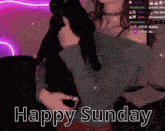 a woman holding a black cat with the words happy sunday