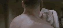 a man and a woman are kissing in a room .