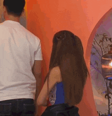 a man and woman are standing next to each other in a room .