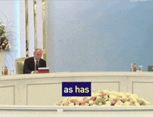 a man is sitting at a table with a sign that says already been said we