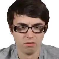 a close up of a man wearing glasses and a gray shirt