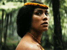 a close up of a woman 's face with a necklace on