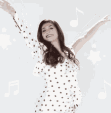 a woman in a white dress with black stars on it