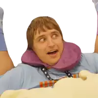 a man wearing a purple neck pillow is laying on a pillow