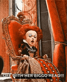 the queen of hearts from alice in wonderland is sitting in a red chair