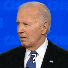 a close up of a man in a suit and tie with a question mark on his forehead .