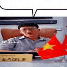 a man sits at a desk with a sign that says eagle on it