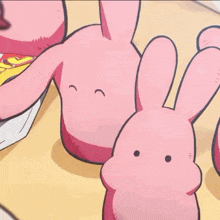 a pink stuffed animal is sitting on a table