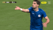 a soccer player in a blue jersey with the dazn.com logo on the bottom