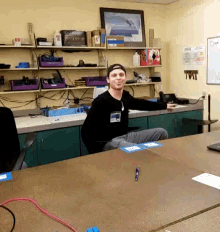 a man sitting at a table with a name tag that says ' tnt '