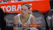 a female basketball player sits on the bench during a game sponsored by albert ban health