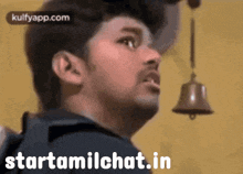 a man is looking up at a bell with the words starttamilchat.in written below him