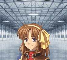a girl with a yellow bow on her head stands in a warehouse