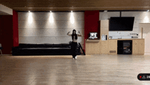 a woman dancing in a room with the number 28 on the bottom