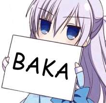 a girl is holding a sign that says baka in front of her face .
