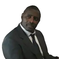 a man in a suit and tie with a beard looks at the camera