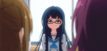 a girl with long blue hair and glasses is sitting in front of a window with two other girls .