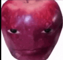 a close up of an apple with a face on it