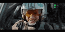 a man wearing a helmet and goggles with the letter t on it