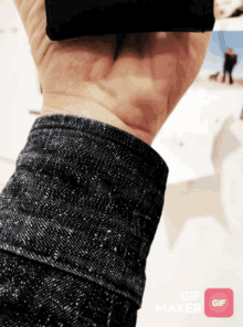 a close up of a person 's wrist with a gif maker icon